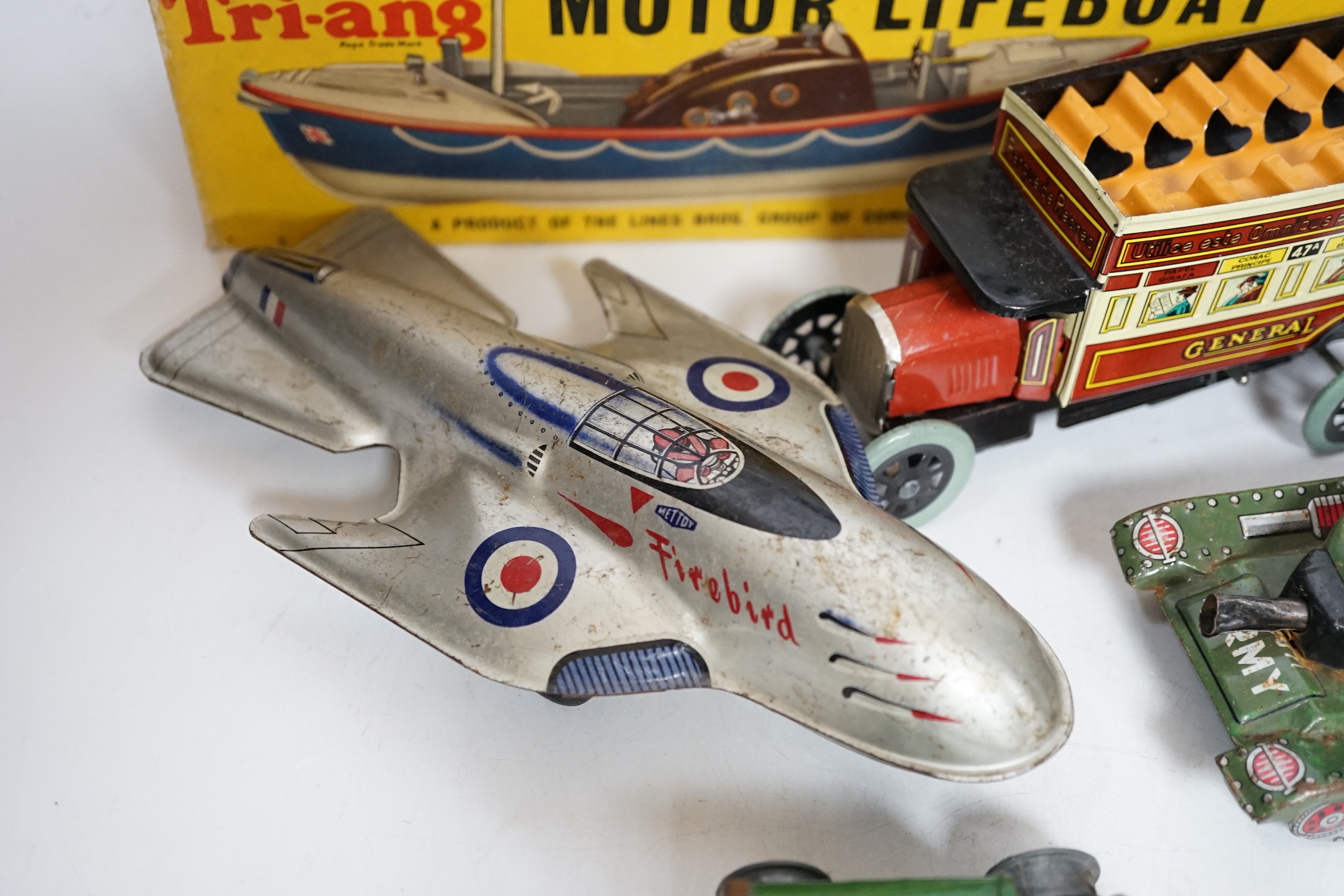 A collection of tinplate toys including cars, a fire engine, a Firebird jet plane, a Tri-ang lifeboat, an Tri-ang Minic tractor, etc. (11), together with a box of boardgames including Vintage Gibson and others; Bandit Ch